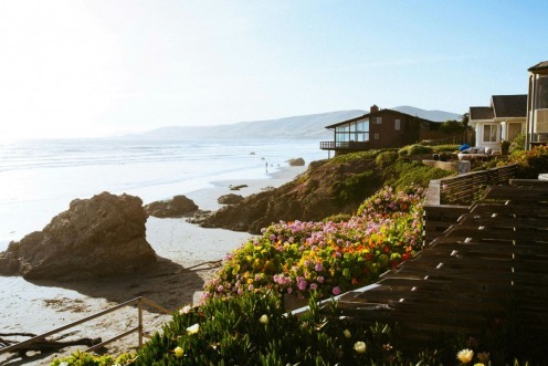 A beautiful brown house on a beach in the morning sky