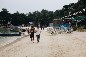 Group of people walking on the seashore.