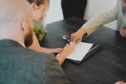 Picture of people signing a document