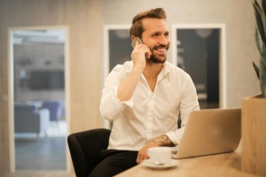 A man talking on the phone while smiling