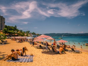 People sunbathing at a sandy beach in Montego Bay.