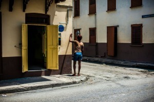 Man standing in front of a yellow door, Barbados